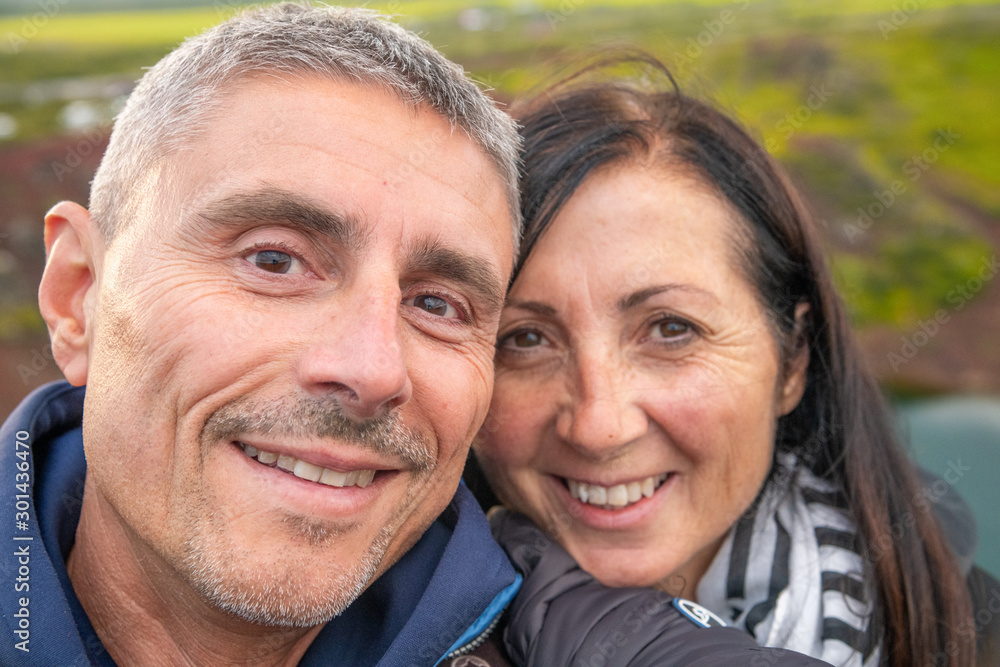 Happy couple taking selfies with Iceland Crater Lake on background Happy couple taking selfies with Iceland Crater Lake on background