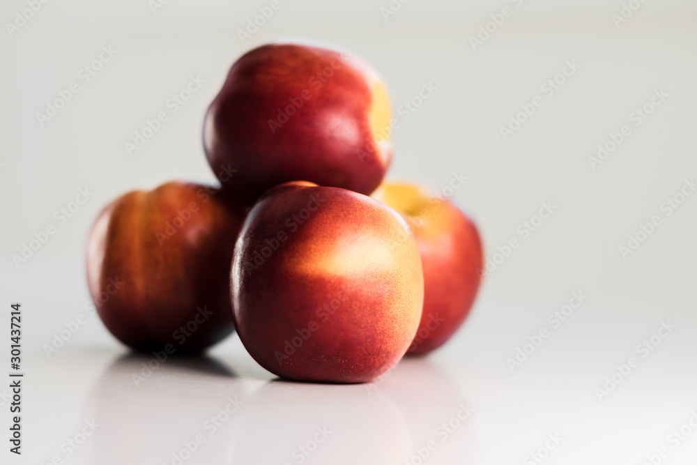 Ripe red nectarines, peaches, apples on a white table. Tasty bright fruits. Isolated object. Ripe red nectarines, peaches, apples on a white table. Tasty bright fruits. Isolated object.
