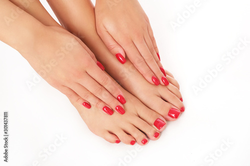 Beautiful red manicure and pedicure isolated on white background.
