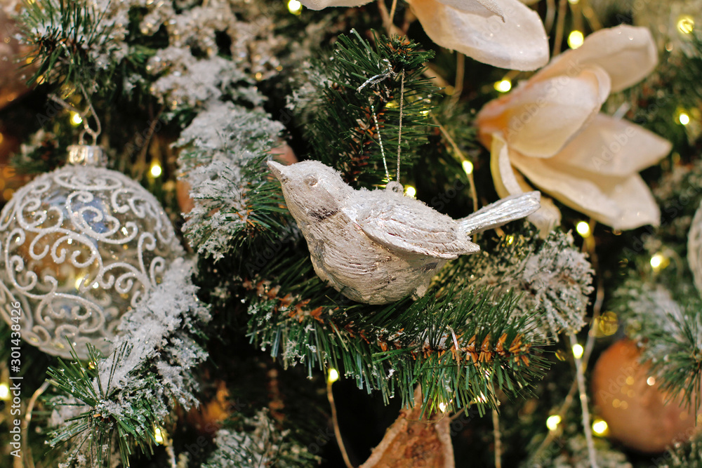 Silver Christmas toy bird hanging on the Christmas tree Silver Christmas toy bird hanging on the Christmas tree