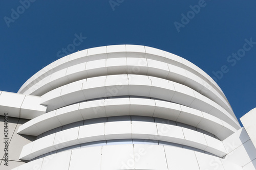 Geometric color elements of the building facade with planes, lines, corners with highlights and reflections for the abstract background and texture of white, gray, blue colors. Place for text