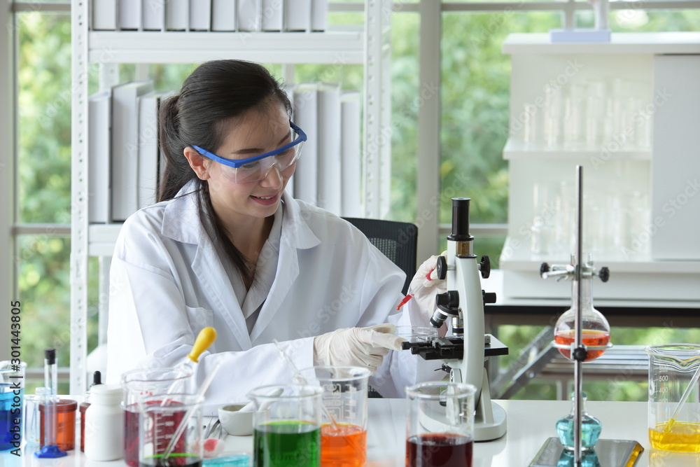 Scientists working in laboratory ,Close-up of a scientistYoung female scientist looking through a microscope in a laboratory doing research, Scientists working in laboratory ,Close-up of a scientistYoung female scientist looking through a microscope in a laboratory doing research,