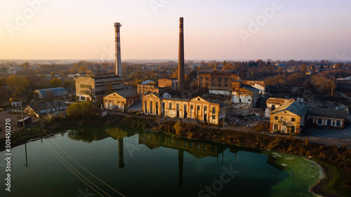 Aerial view of an old factory ruin and broken windows. Old industrial building for demolition.