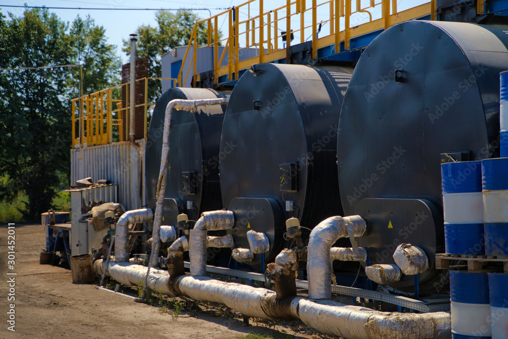 Storage Tanks in blue sky background. Industrial production. Selective focus.