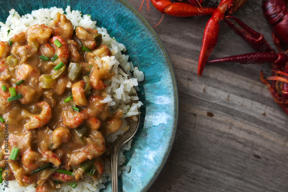 Crawfish etouffee over rice, shown with whole crawfish or crayfish on a