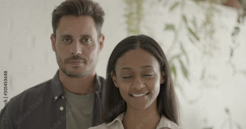 Portrait of Happy Couple looking content at camera in there home Portrait of Happy Couple looking content at camera in there home