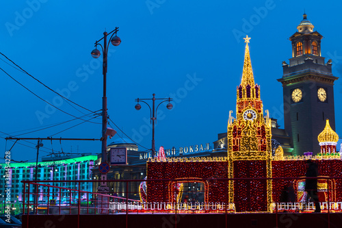 Russia, Moscow, Kievsky Train Station Square,  light installations in the form of the Moscow Kremlin and St. Basil's Cathedral. The building of the Kiev railway station, Clock Tower.  photo