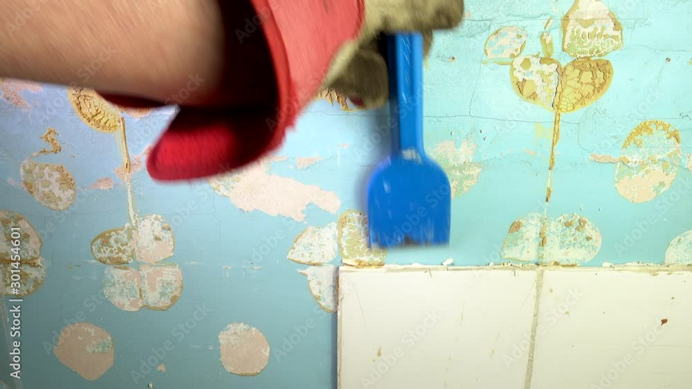 POV close shot of a gloved hand holding a bolster chisel which is being