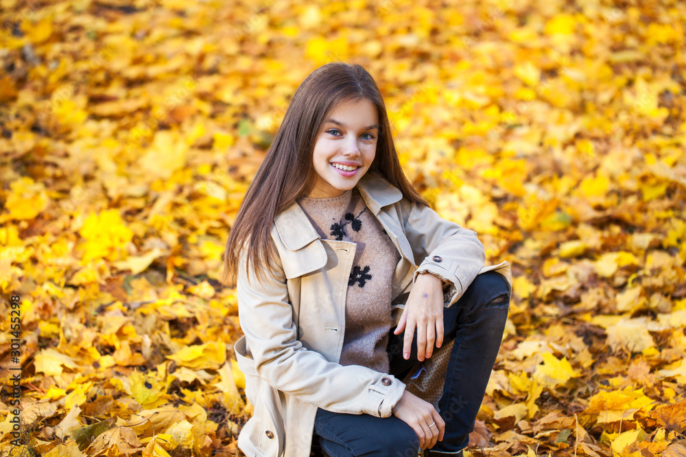 Happy young little girl in beige coat Happy young little girl in beige coat