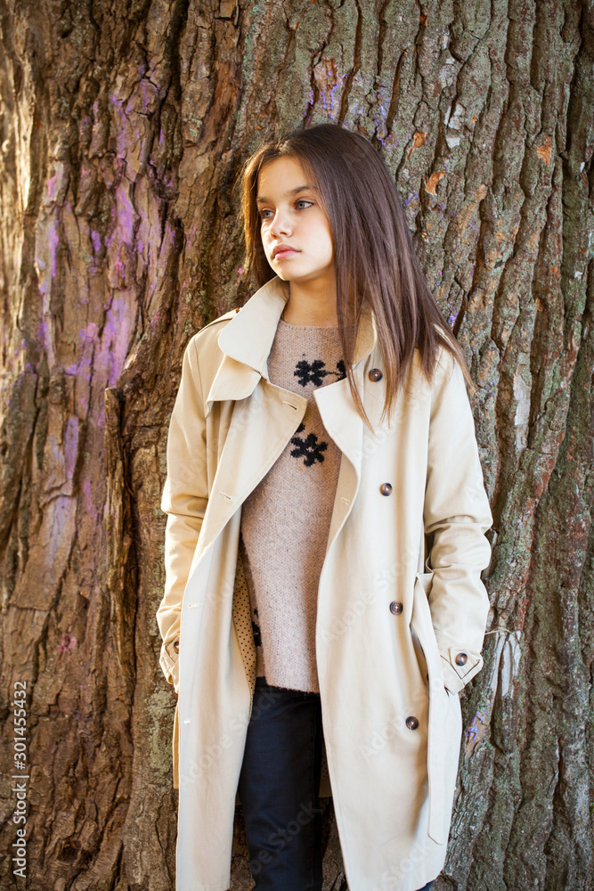 Happy young little girl in beige coat Happy young little girl in beige coat