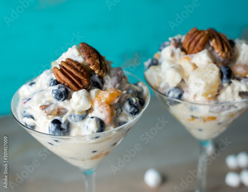 фотографія Two martini glasses filled with ambrosia salad topped with pecan halves