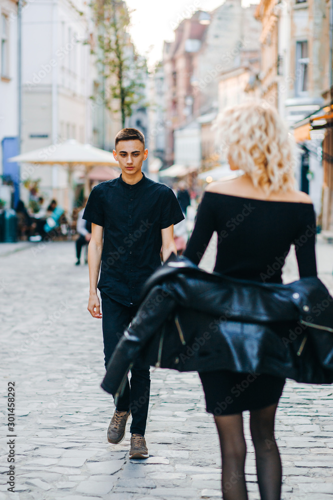 Lovely guy in a black shirt go opposite a posh blonde woman in a leather hen