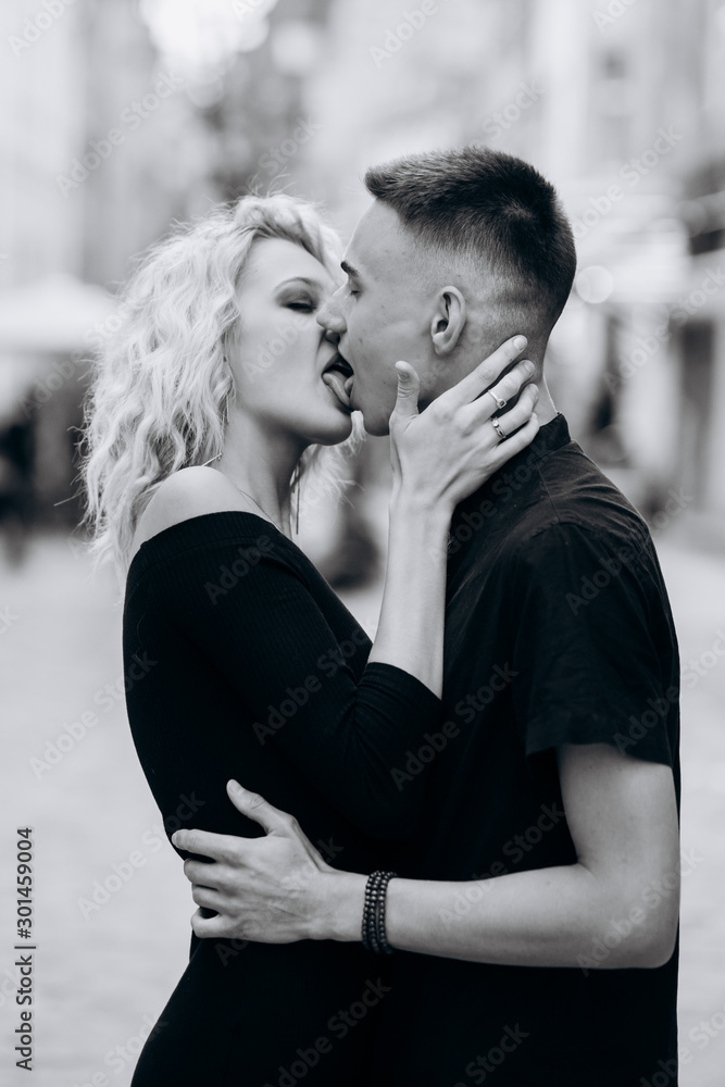 Black and white portrait of loving couple kissing on the street. Hot french  kiss Stock Photo | Adobe Stock