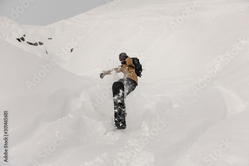 Paralympic snowboarder making a jump trick on the white snow covered hill photo