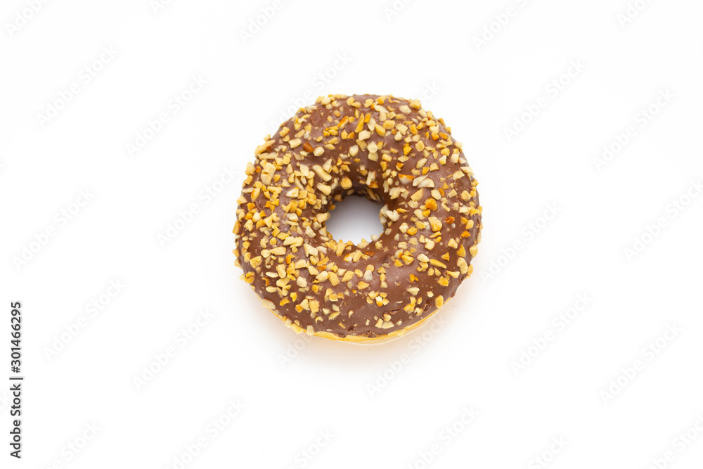 chocolate donut sprinkled with crushed nuts on white background, top view chocolate donut sprinkled with crushed nuts on white background, top view