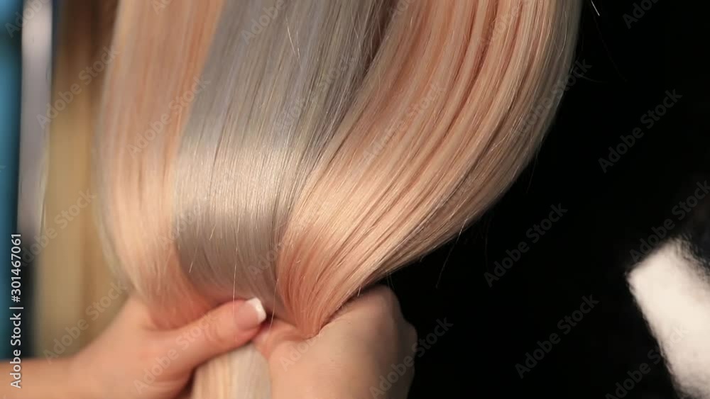 Shiny silky blonde hair extensions closeup Shiny silky blonde hair extensions closeup