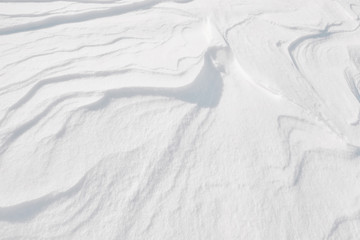 White winter snow on ground texture background. Top down view of natural color of snowy pattern surface in cold season. Christmas New Year celebration theme. Abstract nature wallpaper