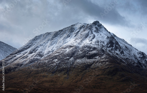 Snowcapped mountain peak in Scottish highlands.