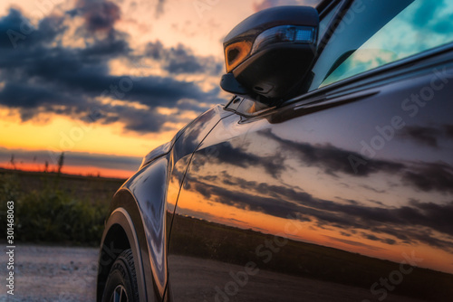 car on the road and sunset photo