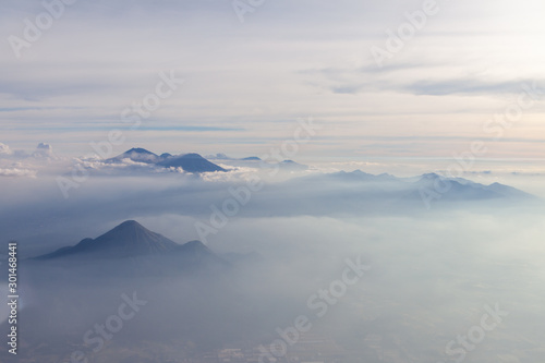 Aerial view of different volcanoes on Java Island. The fog adds to a mystical appearance of these sleeping beauties.