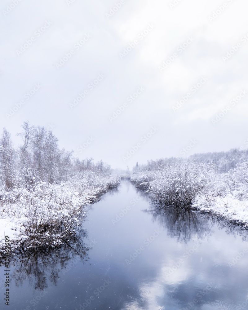 Winter landscape of a calm river and trees covered of first snow. Room for text. (copy space) Winter landscape of a calm river and trees covered of first snow. Room for text. (copy space)