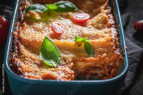 Tasty lasagna baked in casserole with cheese