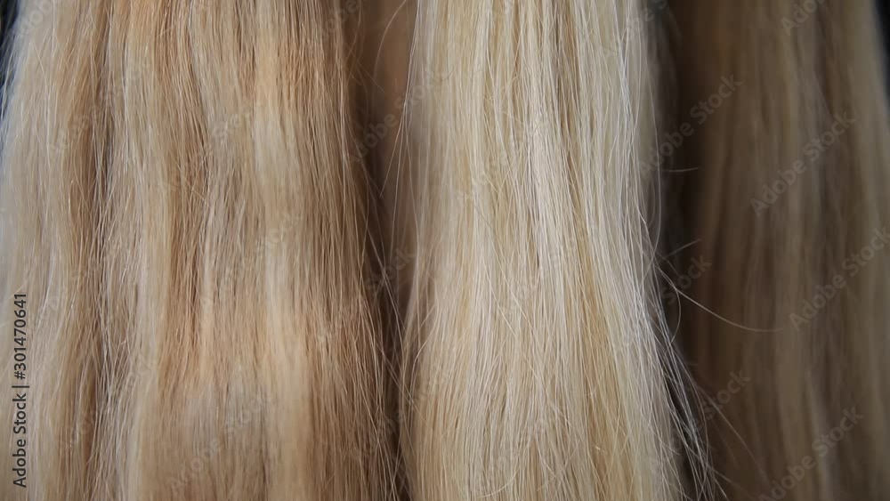 Shiny silky blonde hair extensions closeup Shiny silky blonde hair extensions closeup