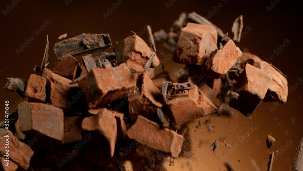 Super slow motion of flying group of raw chocolate pieces. Filmed on high speed cinema camera, 1000fps. Super slow motion of flying group of raw chocolate pieces. Filmed on high speed cinema camera, 1000fps.