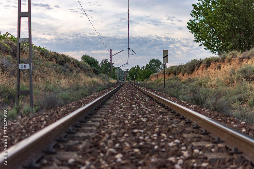 Unique railroad line at the sunset. Train railway track . Low clouds over the railroad.