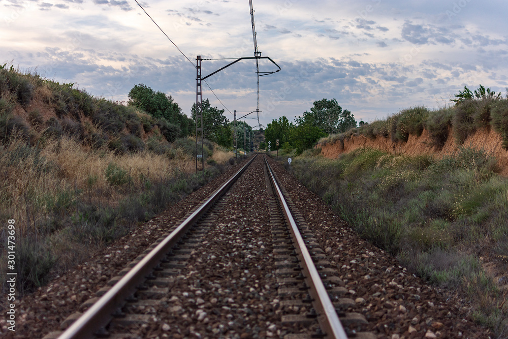 Unique railroad line at the sunset. Train railway track . Low clouds over the railroad. Unique railroad line at the sunset. Train railway track . Low clouds over the railroad.