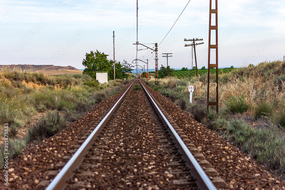 Unique railroad line at the sunset. Train railway track . Low clouds over the railroad.