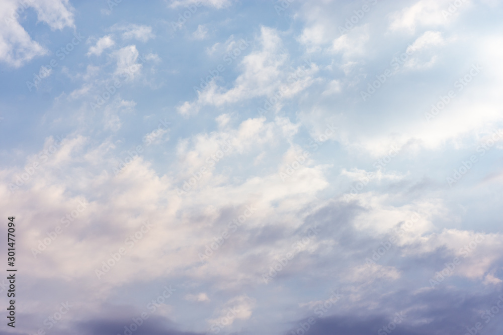 Fototapeta premium landscape sky with blue clouds and sunbeams at sunset. Background texture