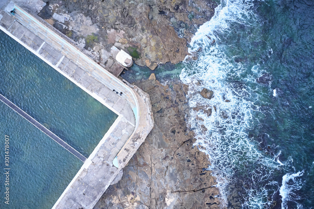 Newcastle ocean baths aerial drone view just after sunrise on overcast day