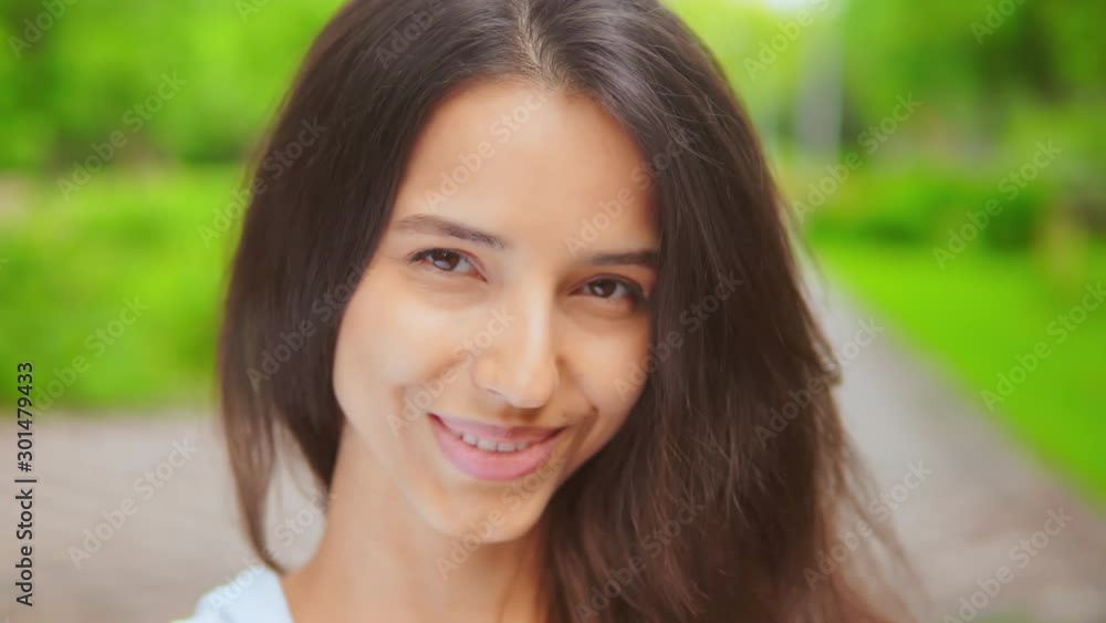 front portrait brunette looking camera happy smiling face attractive young woman posing outdoors front portrait brunette looking camera happy smiling face attractive young woman posing outdoors