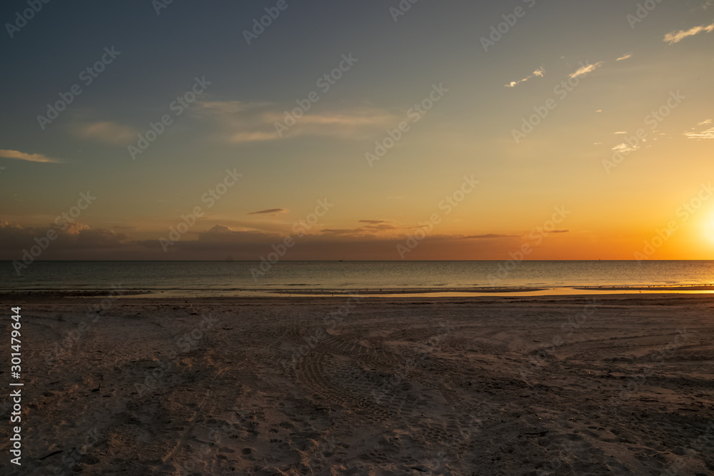 Empty, open beach scene at sunset on Fort Myers Beach, FL along Gulf of Mexico