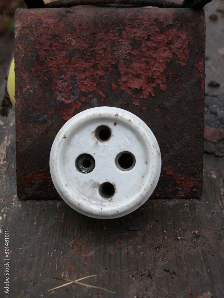 socket against the background of a steel plate with peeling red paint. socket against the background of a steel plate with peeling red paint.