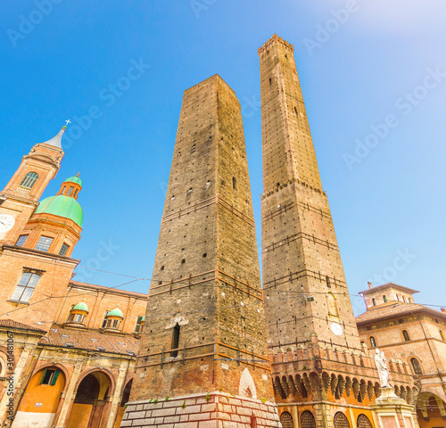 Two medieval towers of Bologna Le Due Torri: Asinelli and Garisenda and Chiesa di San Bartolomeo Gaetano church on Piazza di Porta Ravegnana square in old historical city centre, Emilia-Romagna, Italy photo