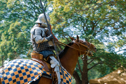 A mounted knight in shining armor readies his lance in preparation for combat in Turku, Finland. 