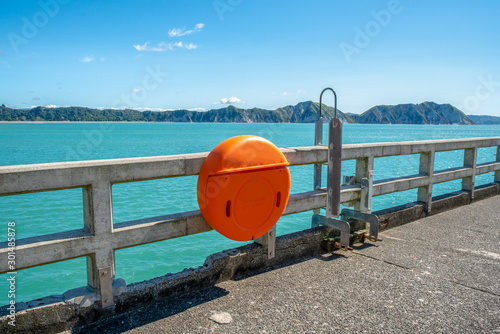 Life saving buoy and equipment on the hand rail on the Tolaga Bay wharf