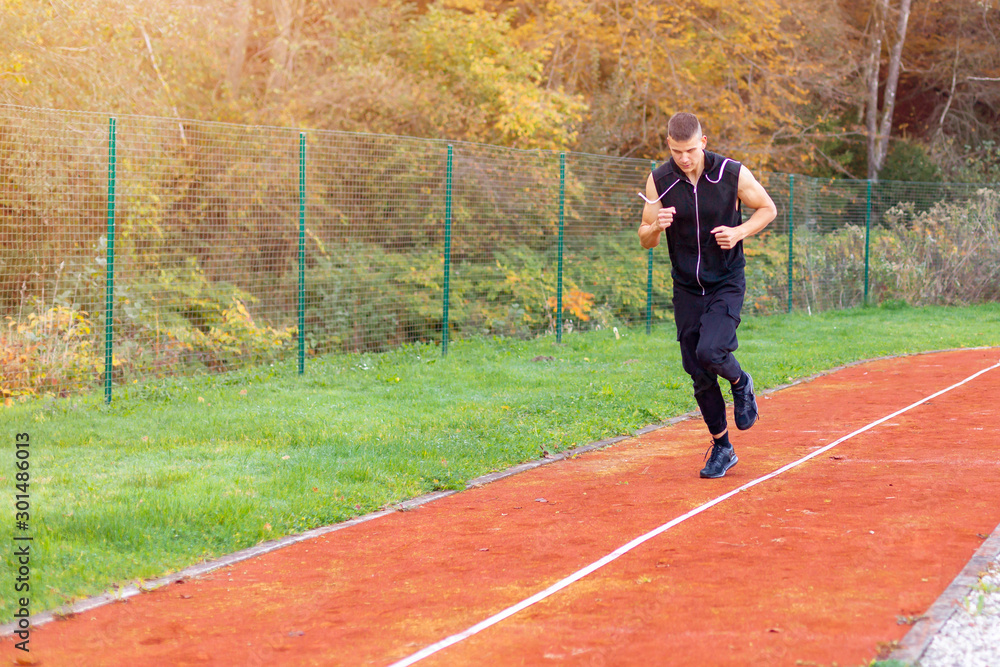 Young man jogging in the morning outdoor on the running race track