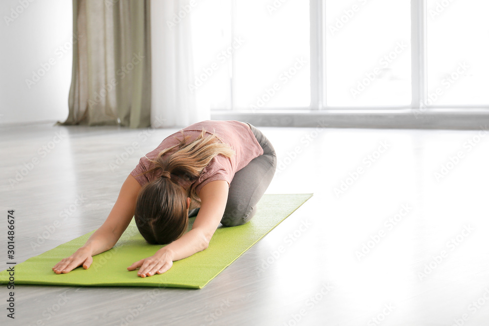 Young woman practicing yoga at home Young woman practicing yoga at home