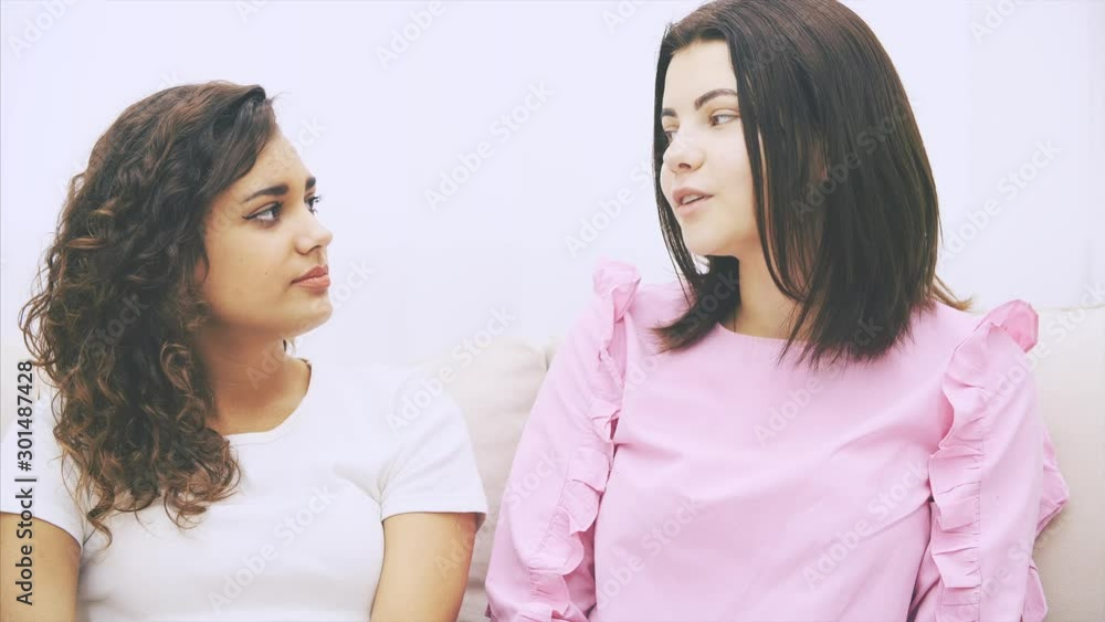 Kinky afro-american kinky girl is telling about her problems, looking upset. Her friend is supporting her, hugging and consoling. Kinky afro-american kinky girl is telling about her problems, looking upset. Her friend is supporting her, hugging and consoling.