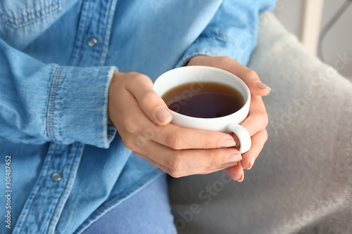Woman's hands holding a whi...