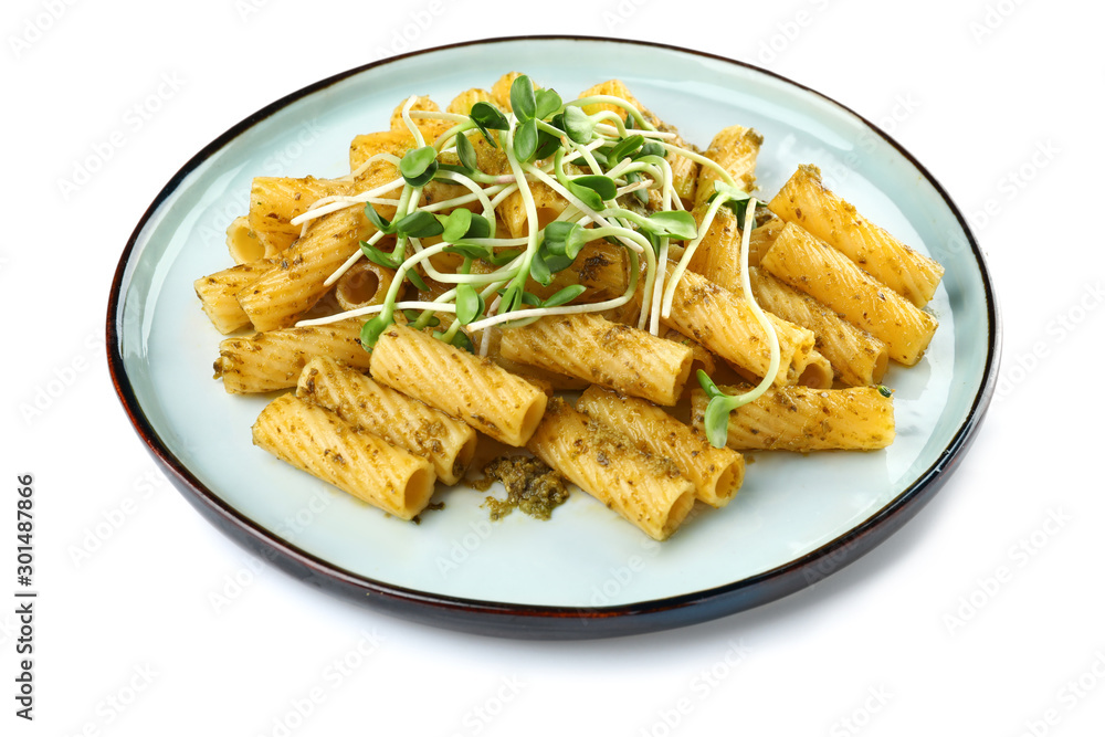 Plate with tasty pasta and pesto sauce on white background Plate with tasty pasta and pesto sauce on white background