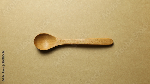 Wooden spoon on brown background