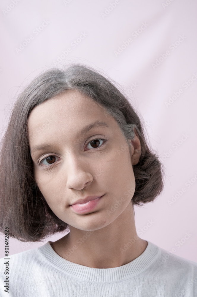 Portrait of a brown-Eyed girl on a pink background Portrait of a brown-Eyed girl on a pink background