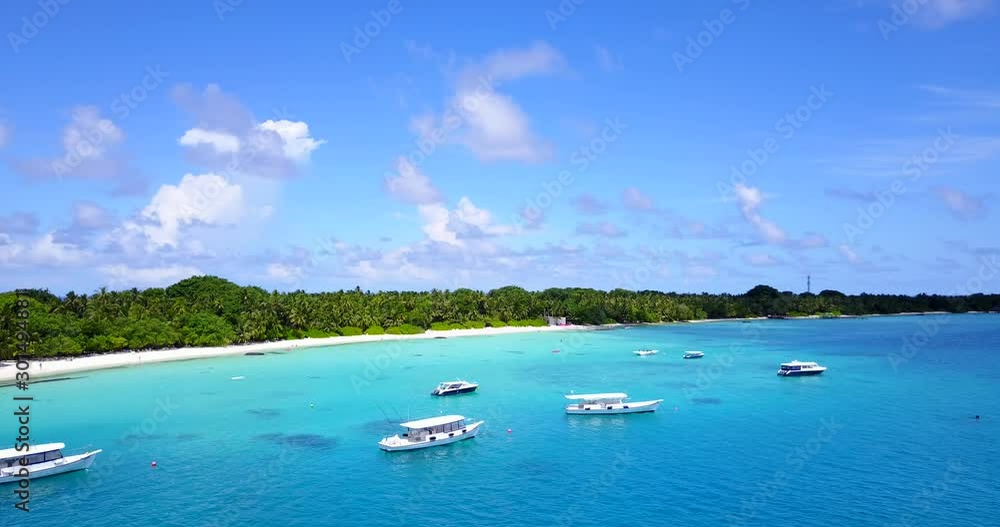 moored boats in the turquoise calm sea near the tropical small island with white beaches and palms moored boats in the turquoise calm sea near the tropical small island with white beaches and palms