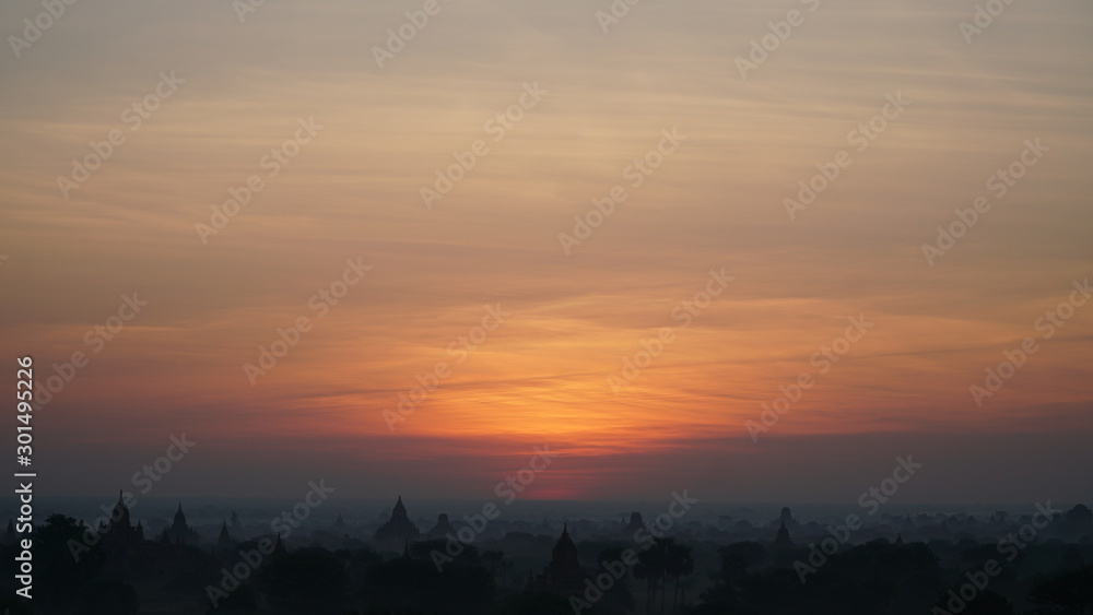 Naklejka premium Landscape Bagan Myanmar with Silhouettes of ancient Buddhist temples, Orange sky sunset