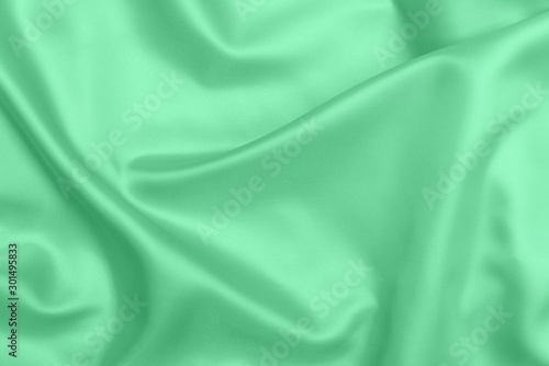 green satin fabric texture soft blur background