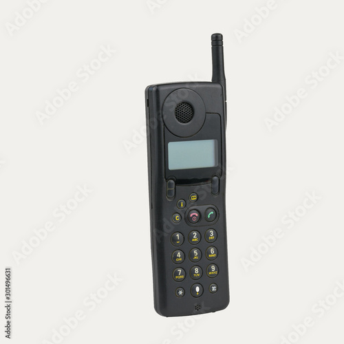 Vintage mobile phone with LCD screen isolated on white background. Retro means of communication.